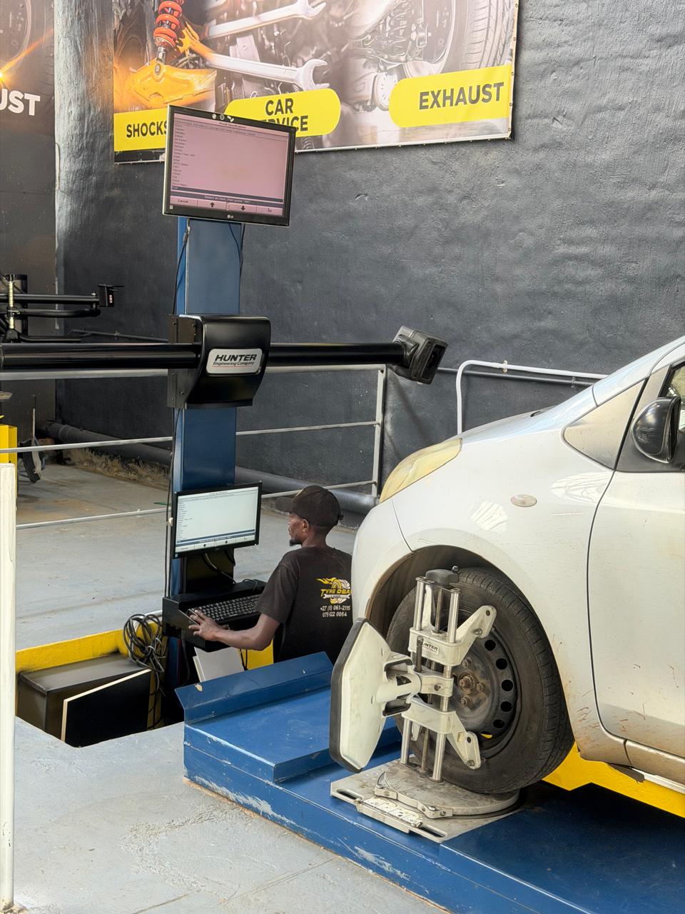 Computerised wheel alignment — technician calibrating system