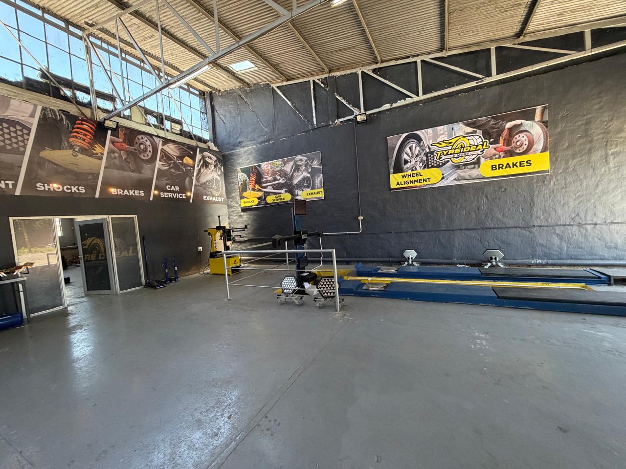 Technicians in branded uniforms working on vehicle