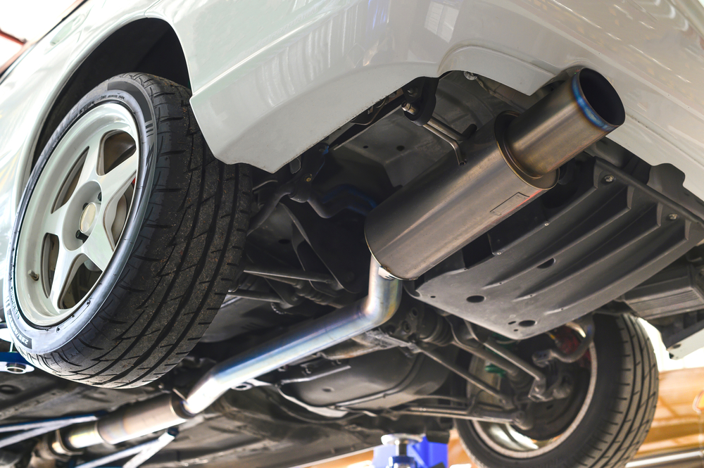 Toyota Corolla elevated for exhaust and underbody inspection